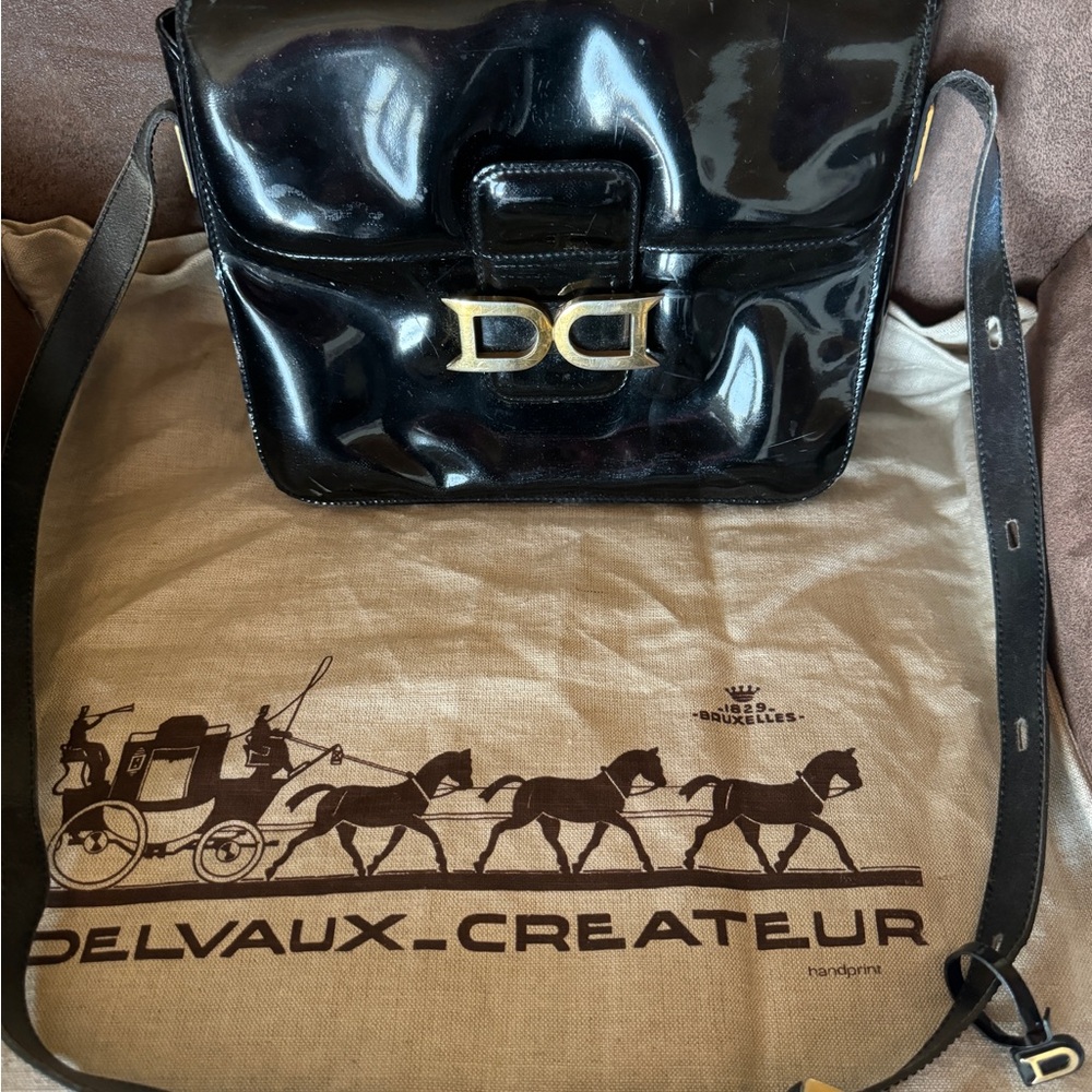 Authentic Delvaux Bourgogne vernis purse with dust bag.